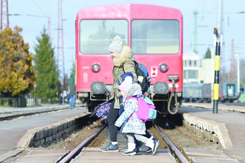 Ukrainian refugees arrive at the railway station in the Hungarian-Ukrainian border town of Zahony.- AFP

