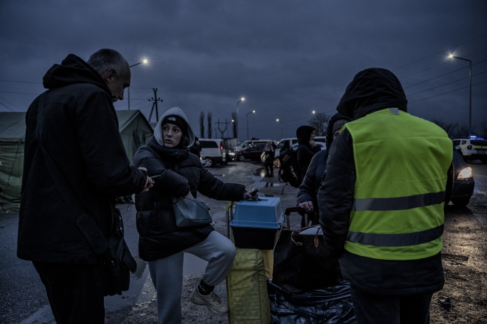 People plan their next travels at a temporary camp for Ukrainian refugees in Palanca, Moldova, March 1, 2022. (Laetitia Vancon/The New York Times)