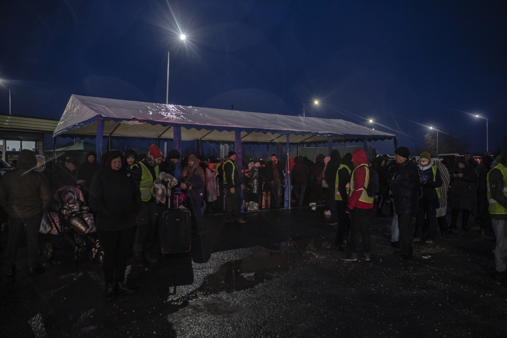 People plan their next travels at a temporary camp for Ukrainian refugees in Palanca, Moldova, March 1, 2022. (Laetitia Vancon/The New York Times)