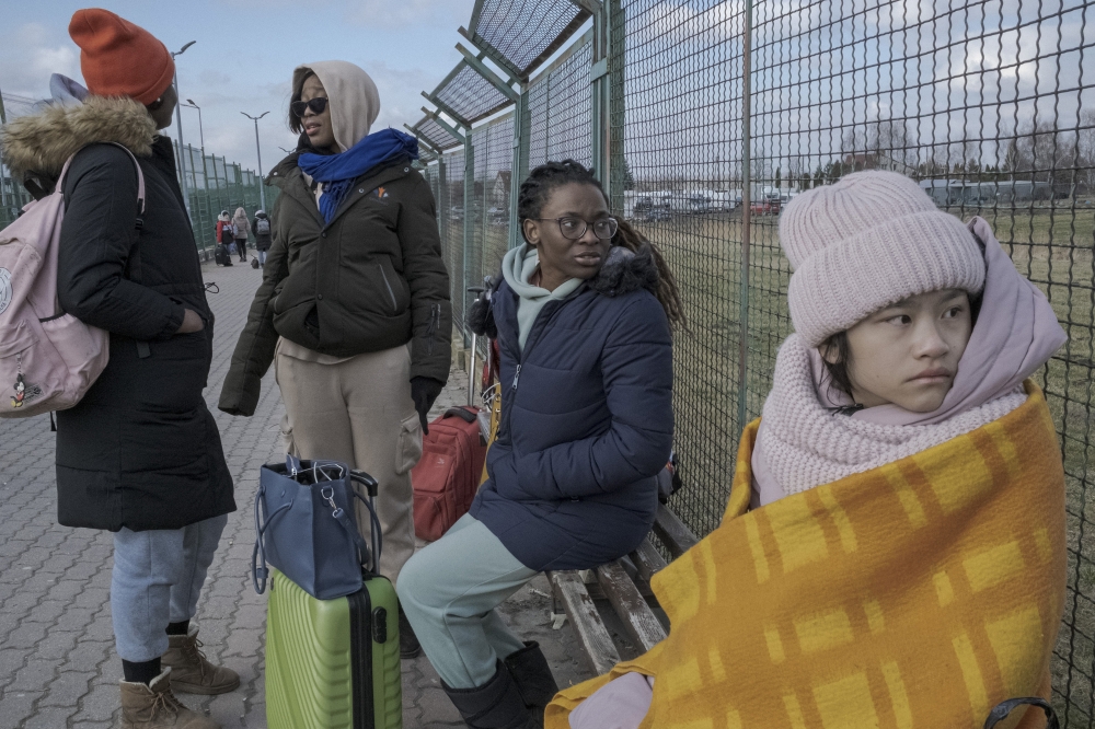 Students from Congo and China, who were all living in Ukraine, wait for friends to arrive after crossing into Poland at the pedestrian border crossing in Medyka, Poland, Feb. 28, 2022.  (Mauricio Lima/The New York Times)