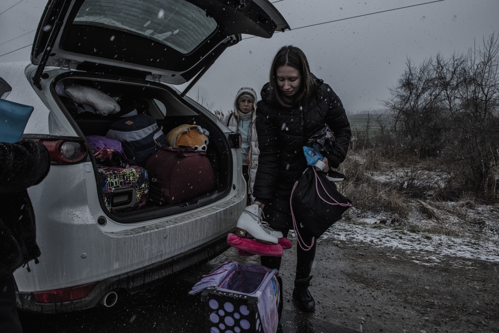 Anna Rogachova packs her daughter’s figure skates, which they brought after fleeing Odessa, Ukraine, at a temporary camp for refugees in Palanca, Moldova, March 1, 2022. (Laetitia Vancon/The New York Times)