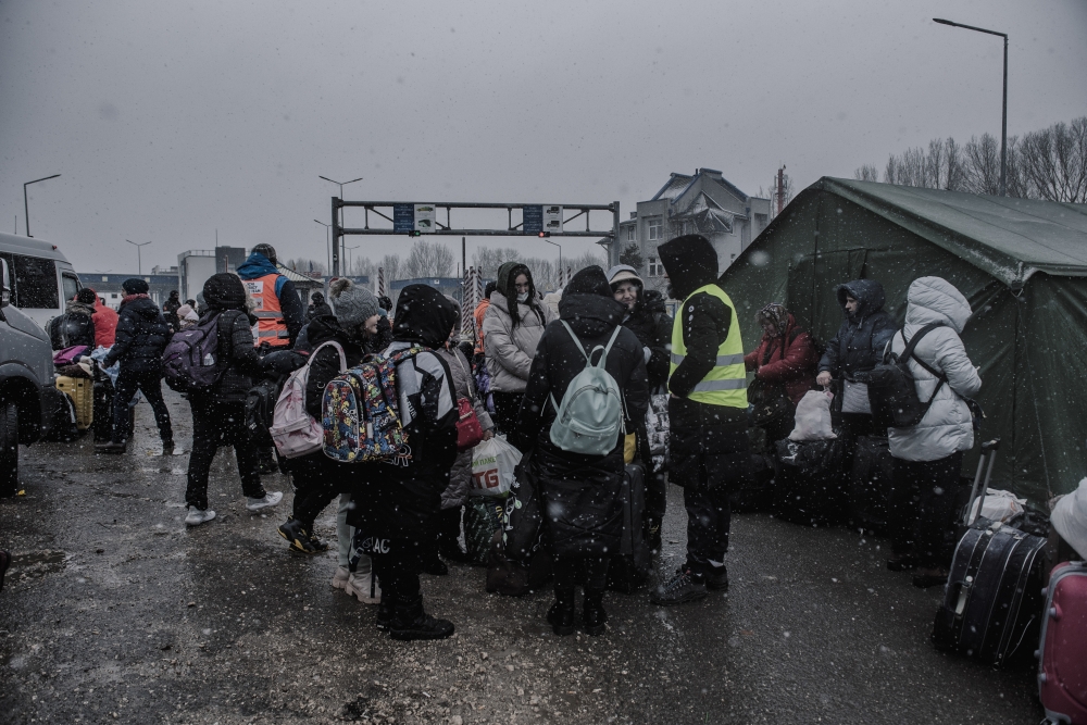 Refugees who recently crossed the border from Ukraine rest before moving on from a temporary camp in Palanca, Moldova, March 1, 2022. (Laetitia Vancon/The New York Times)