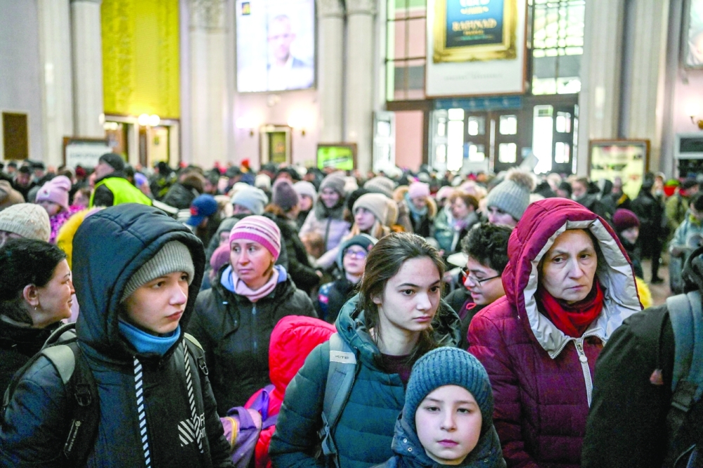Ukrainians wait in a long queue to board a train to Poland in Lviv central train station. -- AFP
