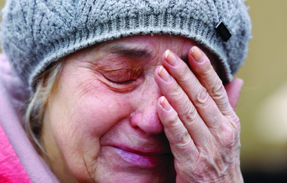 A woman reacts as crossing the border from Ukraine to Poland after fleeing the Russian invasion of Ukraine, in Medyka, Poland. — Reuters