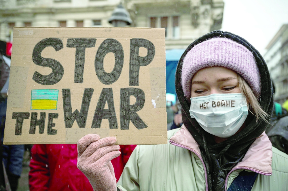 A protester holds a sign during a demonstration in Belgrade on March Sunday. - AFP