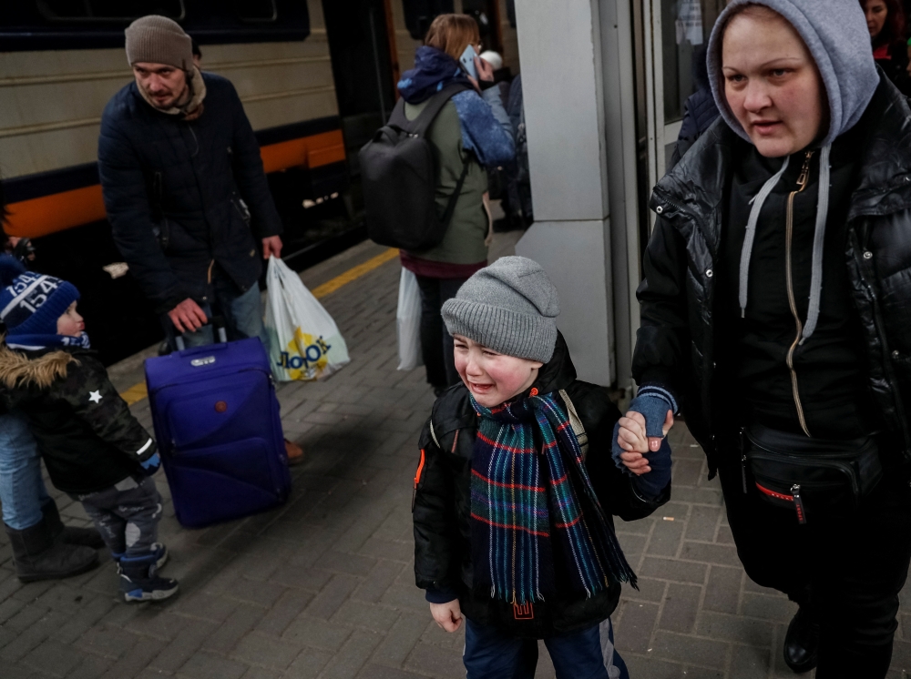 People board an evacuation train at Kyiv central train station in Kyiv
