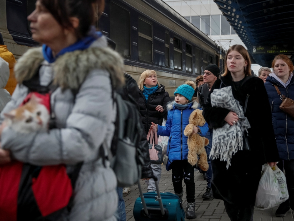 People board an evacuation train at Kyiv central train station in Kyiv