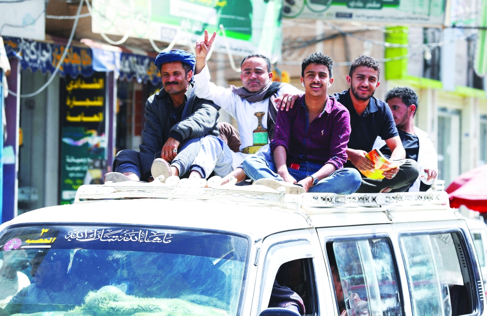 People ride atop a crowded taxi van amid acute fuel shortages in Sanaa. - Reuters  
