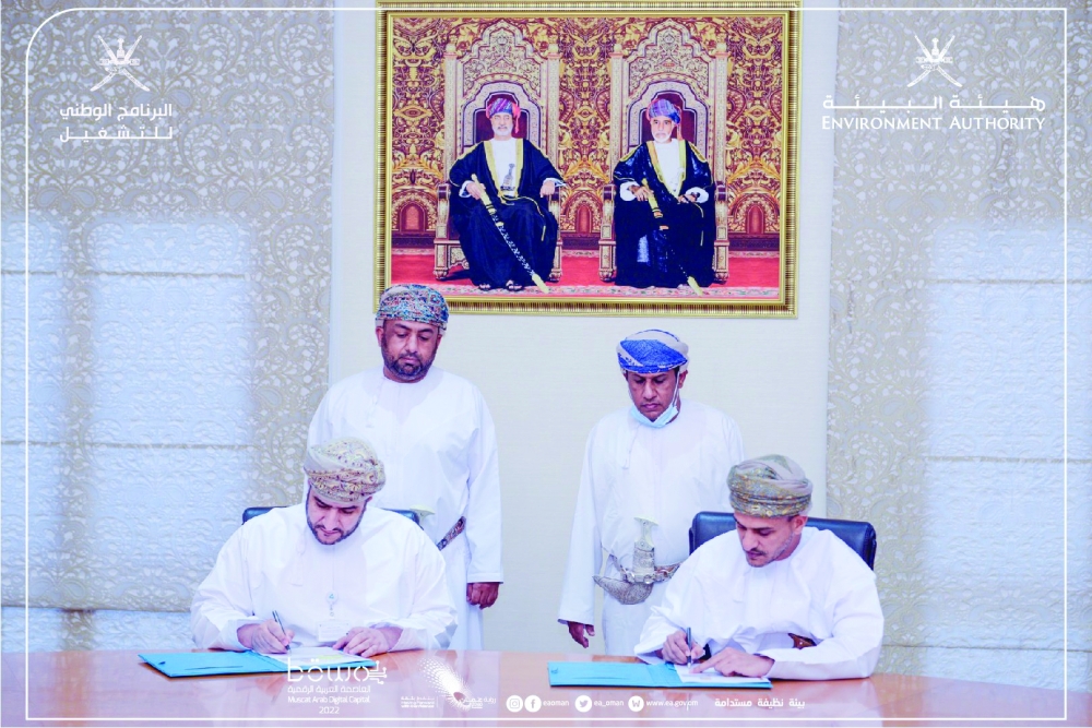Dr Abdullah al Omari, President of the Environment Authority, signs the agreement with Dr Mansoor bin Talib al Hinai of the National Programme for Employment.