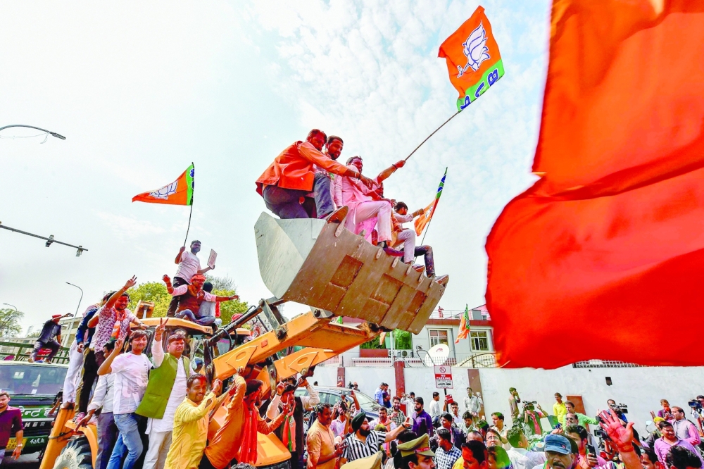 Supporters of India's Bharatiya Janata Party celebrate outside the party office in Lucknow. -- AFP


