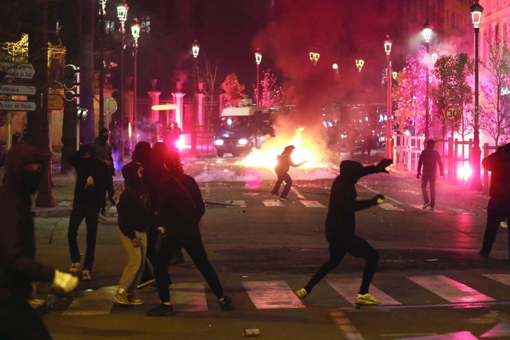 Protesters throw stones and flares at French gendarmes in Ajaccio during a demonstration in support to Yvan Colonna who was assaulted by a fellow inmate at the Arles prison. -- AFP