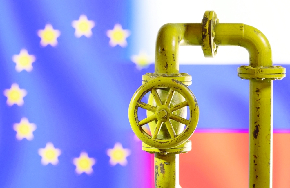 FILE PHOTO: Illustration shows natural gas pipeline in front of word EU and Russia flag colours