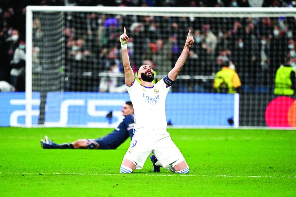 Real Madrid’s French forward Karim Benzema celebrates after scoring a goal during the Uefa Champions League round of 16 second-leg match against Paris Saint-Germain at the Santiago Bernabeu stadium in Madrid. — AFP