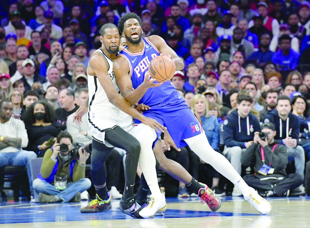 Philadelphia 76ers center Joel Embiid (21) is fouled by Brooklyn Nets forward Kevin Durant (7) during the first quarter at Wells Fargo Center. -- USA Today Sports
