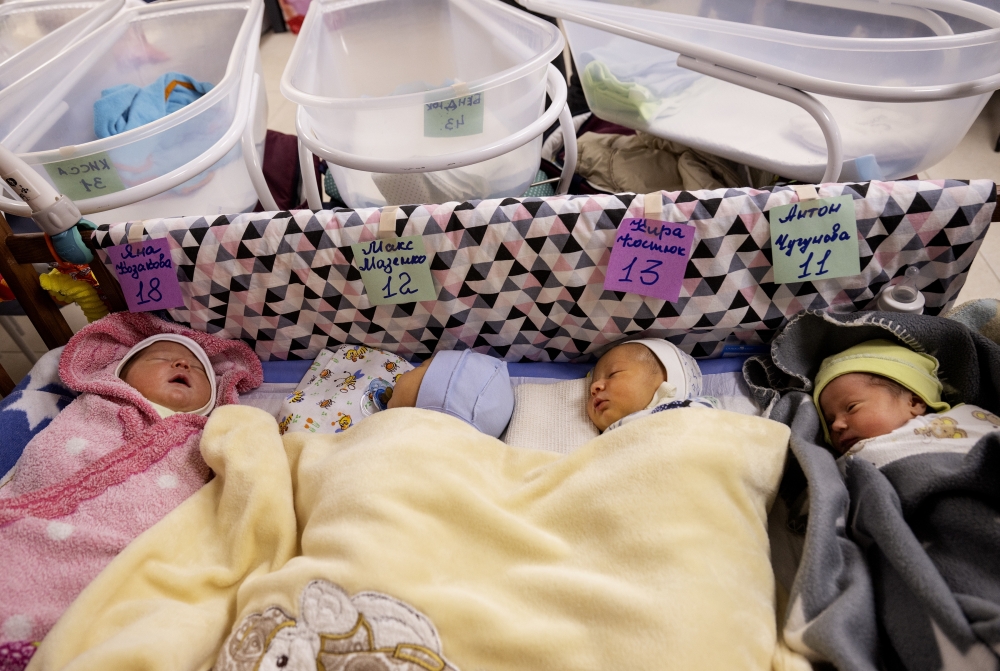 Some of a group of 19 babies born to Ukrainian surrogate mothers, now being cared for by nannies and sheltered during the Russian invasion at a basement nursery with numbered cribs and names given to them by staff, in Kyiv, March 11, 2022. (Lynsey Addario/The New York Times)