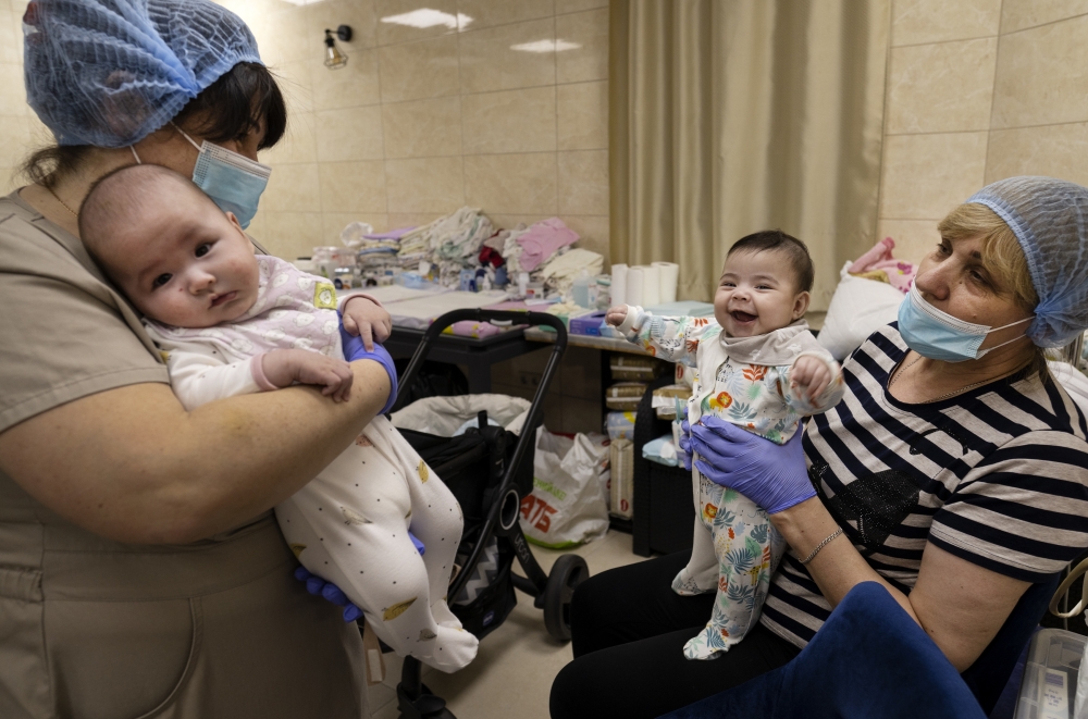 Nannies care for some of the 19 babies born to Ukrainian surrogate mothers that are now sheltered during the Russian invasion at a basement nursery in Kyiv, March 11, 2022. (Lynsey Addario/The New York Times)