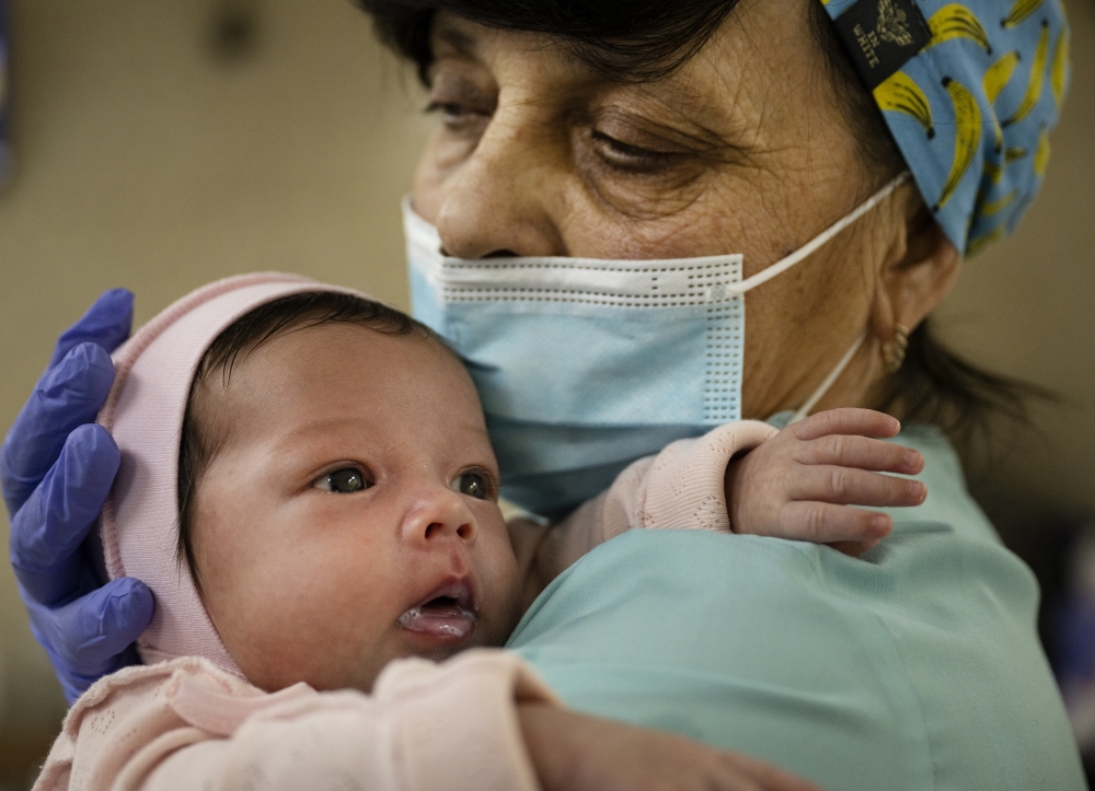 Svitlana Stetsiuk, 50, helps to care for one of 19 babies born to Ukrainian surrogate mothers, now sheltered during the Russian invasion at a basement nursery in Kyiv, March 11, 2022. (Lynsey Addario/The New York Times)