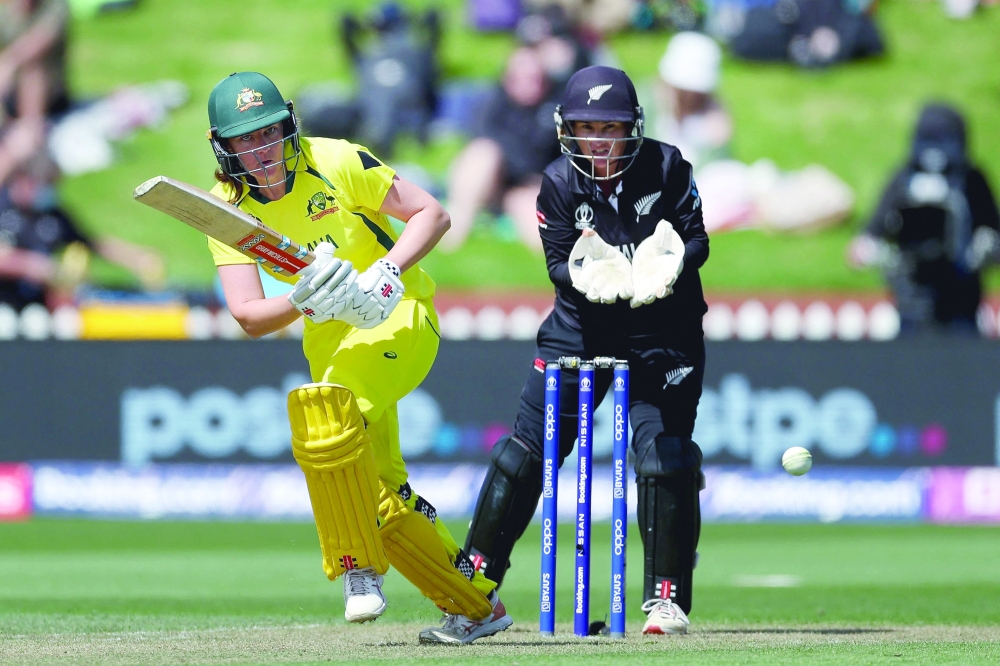Australia's Tahlia McGrath (L) plays a shot with New Zealand's wicketkeeper Katey Martin. -- AFP