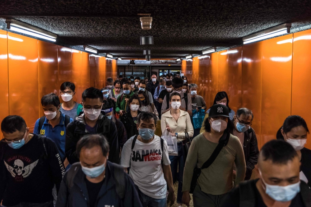 People walk through a train station in Hong Kong on March 14, 2022, amid the city's worst-ever coronavirus outbreak. 