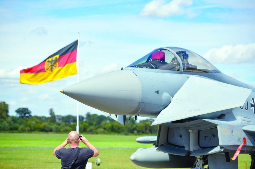 This file photo shows a man taking pictures of an Eurofighter jet of the German Air Force on the tarmac of the German Armed Forces (Bundeswehr) airbase in Noervenich, western Germany. — AFP