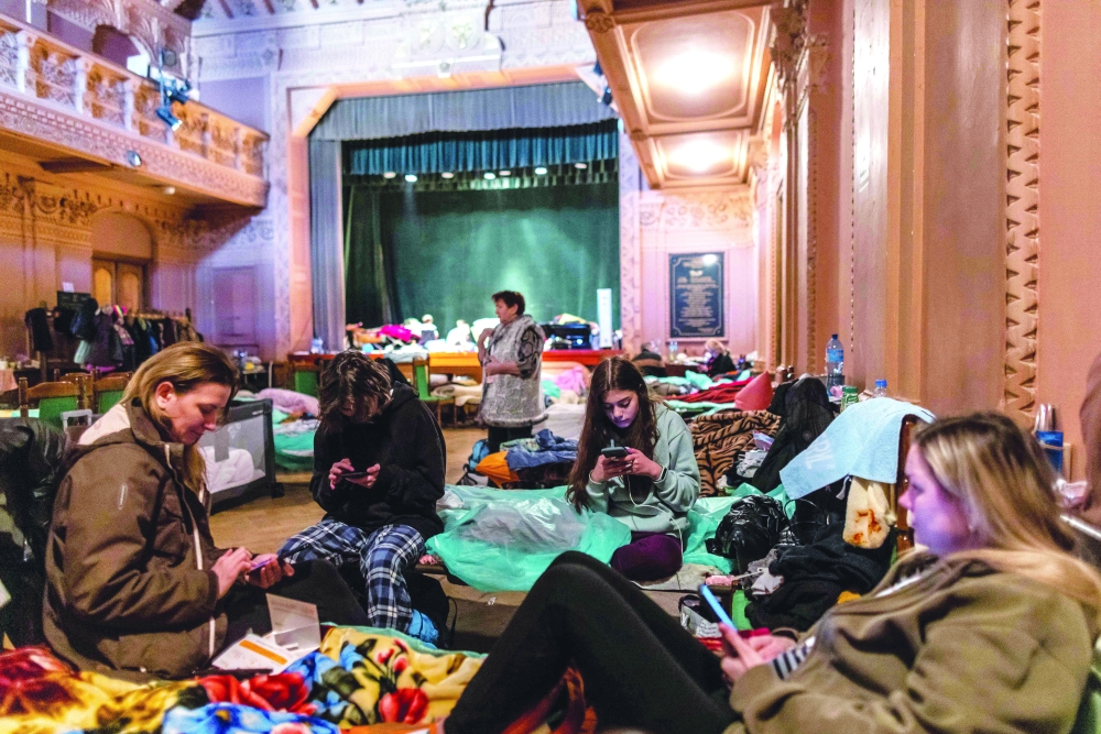 Ukrainians are seen at a theatre converted into a shelter for refugees in Przemysl, Poland. -- Reuters
