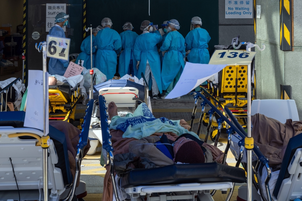 Patients outside a temporary triage area at the Caritas Medical Center in Hong Kong on Feb. 28, 2022. 