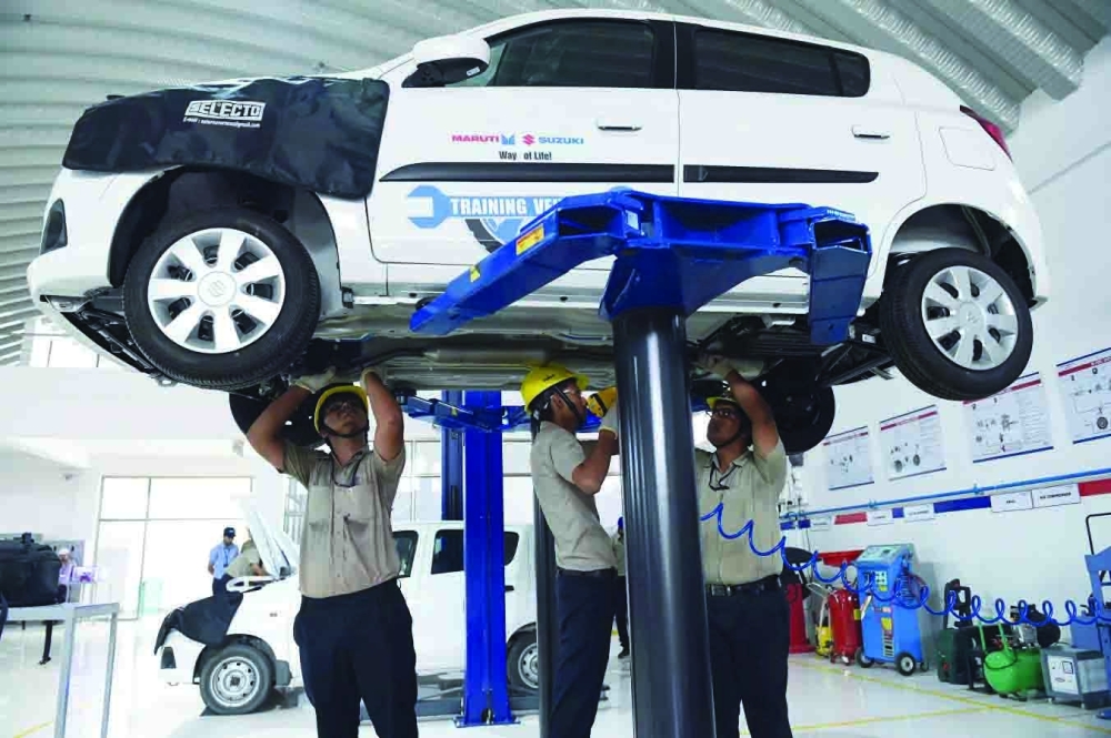 Students attend a car workshop sponsored by Maruti Suzuki India Ltd at Ganpat University in Khenva, some 85 kms from Ahmedabad. — AFP