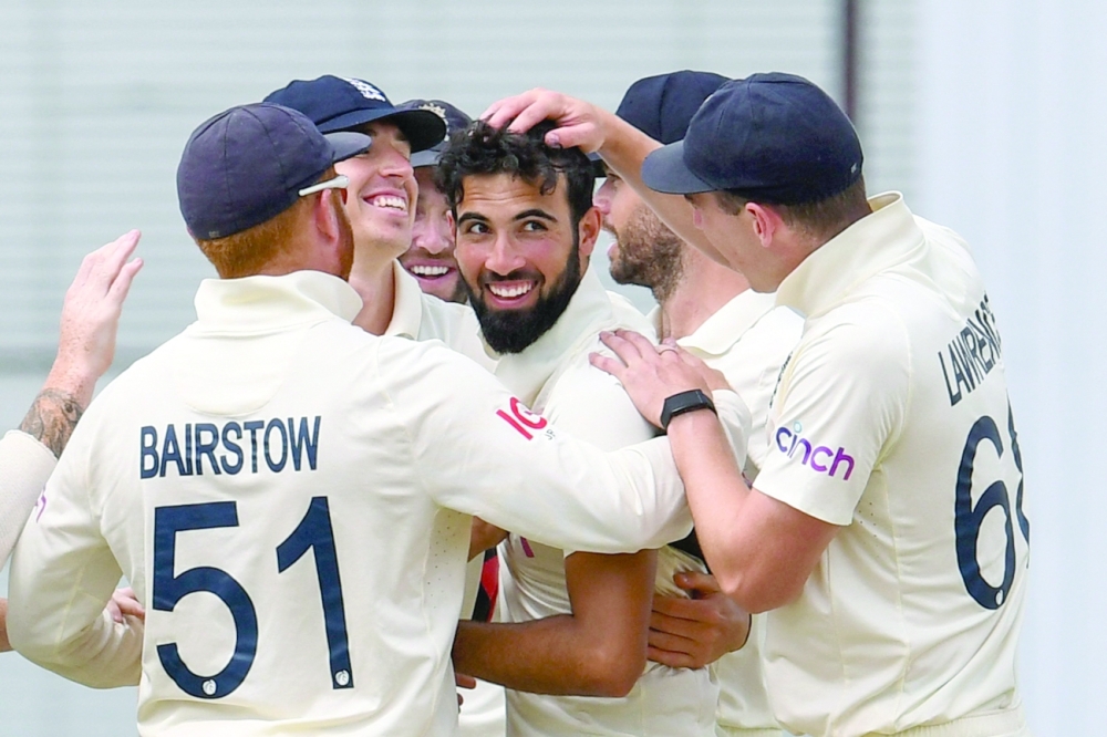 Saqib Mahmood (C) of England celebrates the dismissal of Jason Holder of West Indies during the 4th day of the 2nd Test. -- AFP