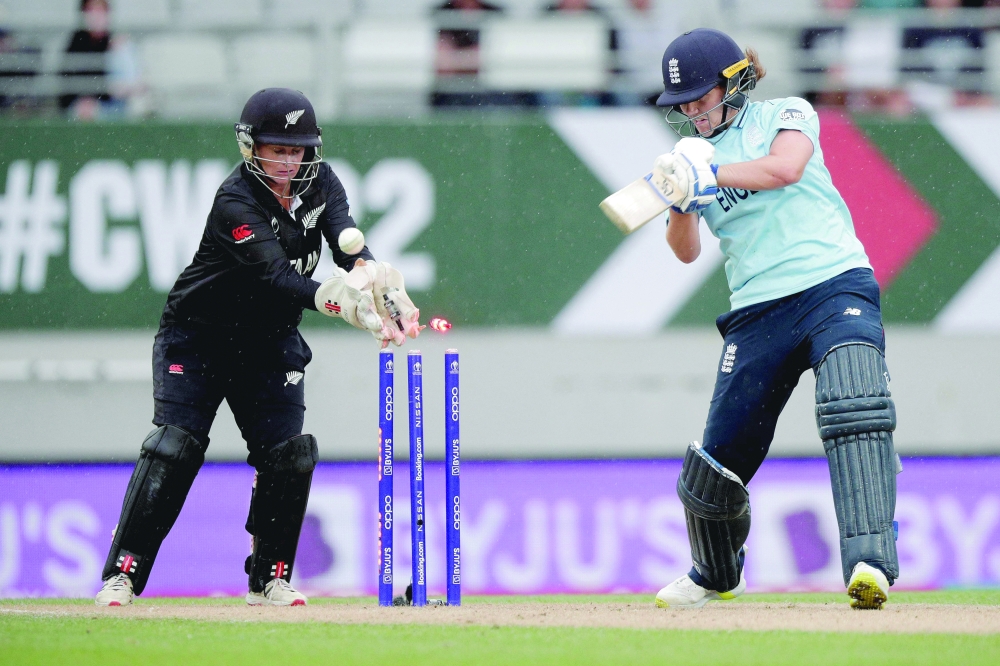 England's Natalie Sciver is clean bowled by New Zealand's Jess Kerr during the 2022 Women's Cricket World Cup match in Auckland. -- AFP