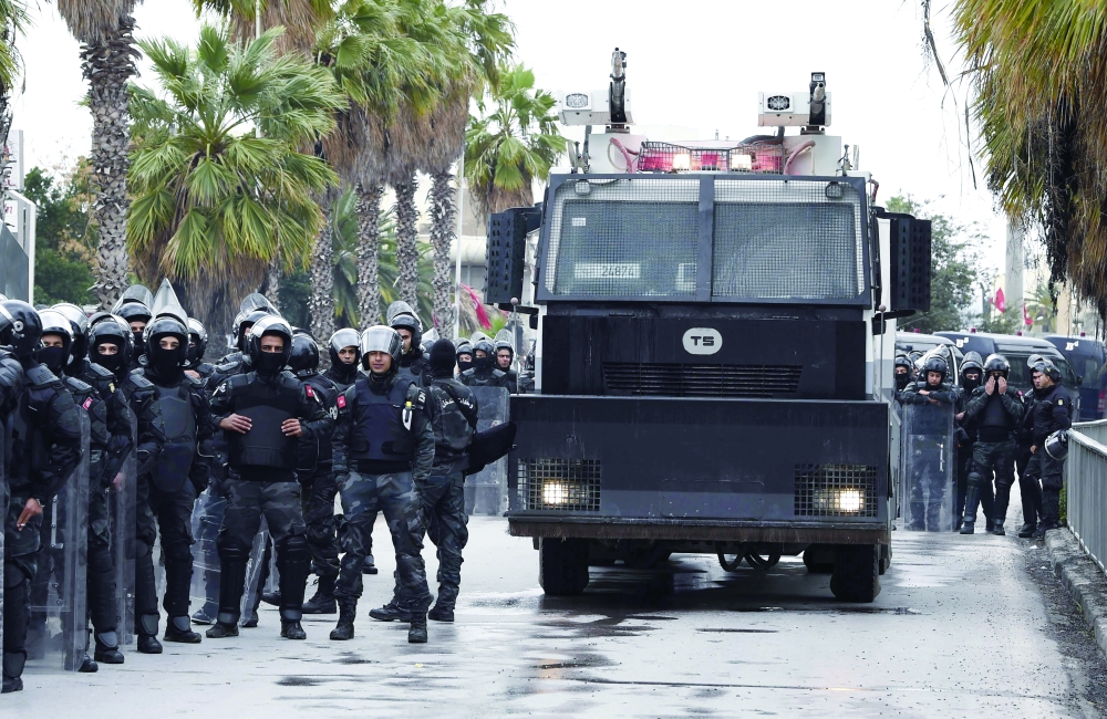 Tunisian security forces during a protest against the country's president in Tunis. - AFP
