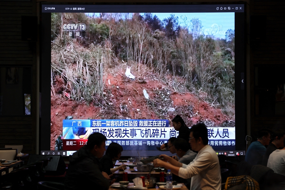 Screen shows new footage of the site where a China Eastern Airlines Boeing 737-800 plane crashed, at a restaurant in Beijing