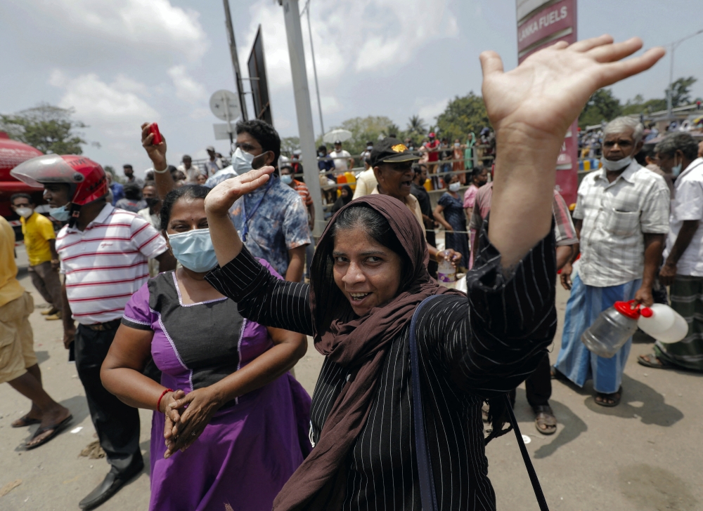 People queue to buy kerosene at a fuel station in Colombo