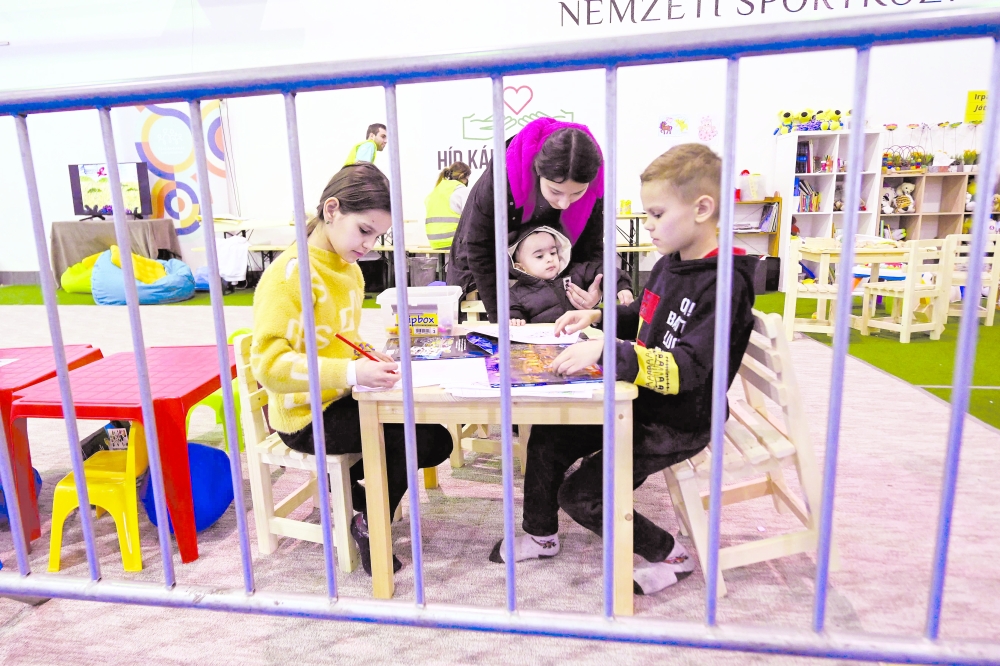 Ukrainian children play in a makeshift playground at the BOK sports hall where a new transit shelter for Ukrainian refugees was installed in Budapest. - AFP