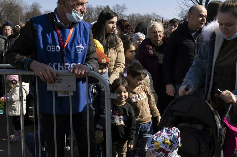 Refugees from Ukraine wait in line for identification documents outside the National Stadium in Warsaw, Poland, on Monday, March 21, 2022.  (Maciek Nabrdalik/The New York Times)