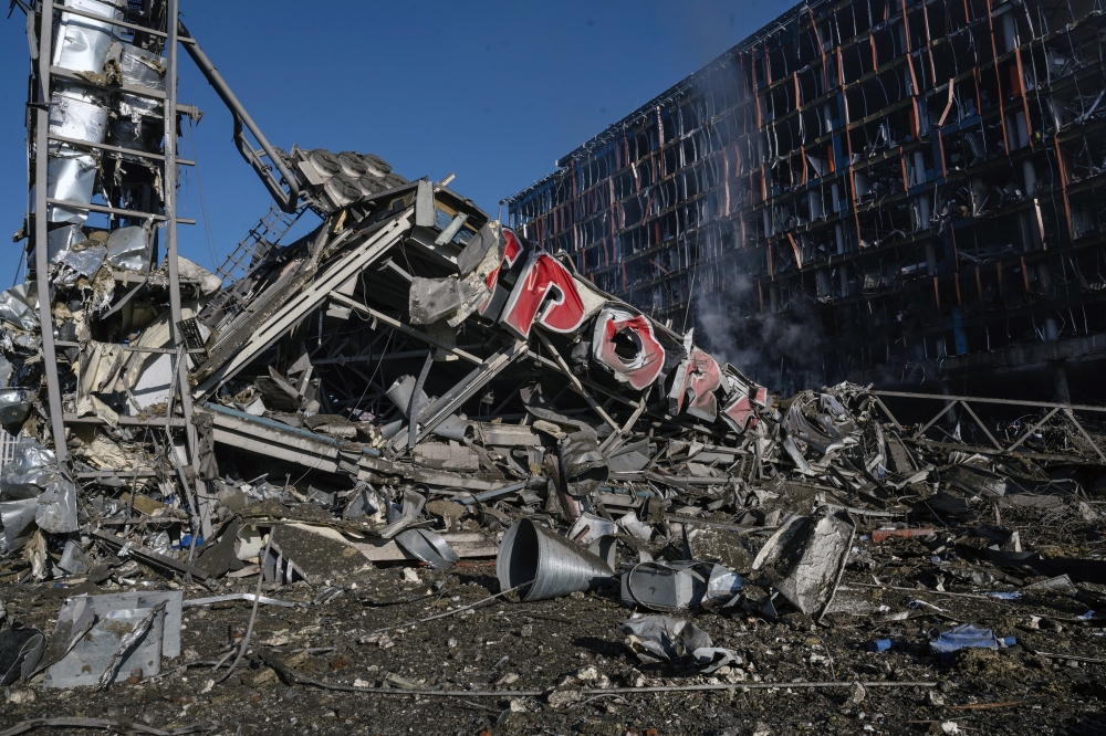 The scene after a Russian missile strike reduced a sprawling shopping mall in Kyiv to a smoldering ruin on Monday, March 21, 2022, one of the most powerful strikes to rock the center of the Ukrainian capital since the war began last month. (Lynsey Addario/The New York Times)