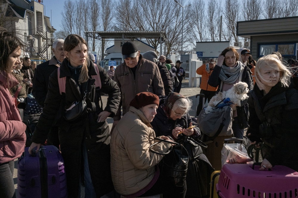 Refugees who fled the fighting in Ukraine wait for a bus for the next leg of their journey after arriving in Palanca, in eastern Moldova, on Tuesday, March 22, 2022. Refugees who fled the fighting in Ukraine wait for a bus for the next leg of their journey after arriving in Palanca, in eastern Moldova, on Tuesday, March 22, 2022. (Mauricio Lima/The New York Times)