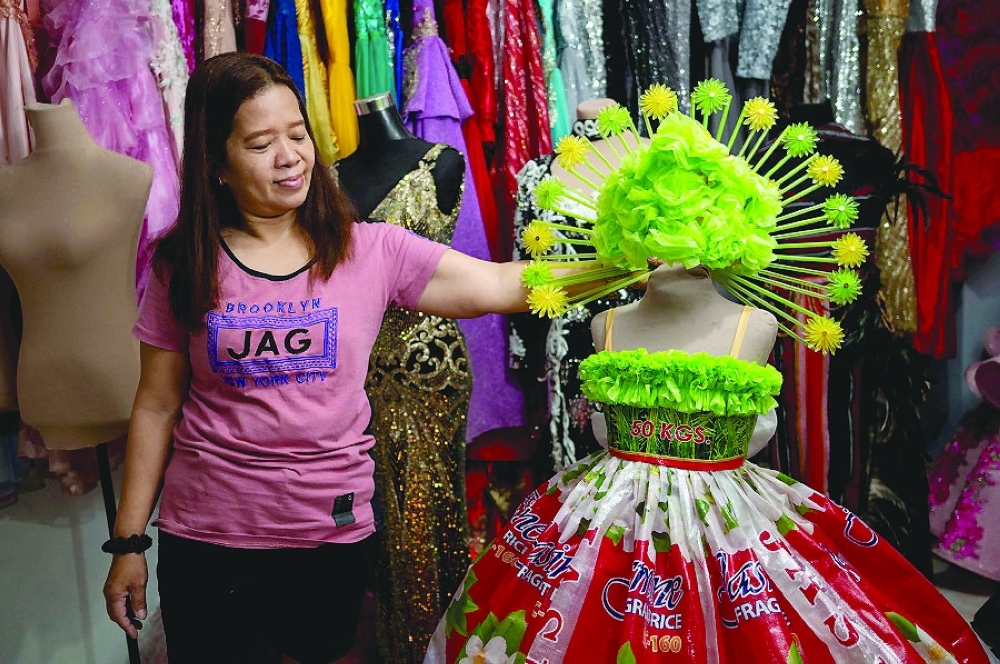 Dressmaker sews clothing out of recycled materials, in Cainta