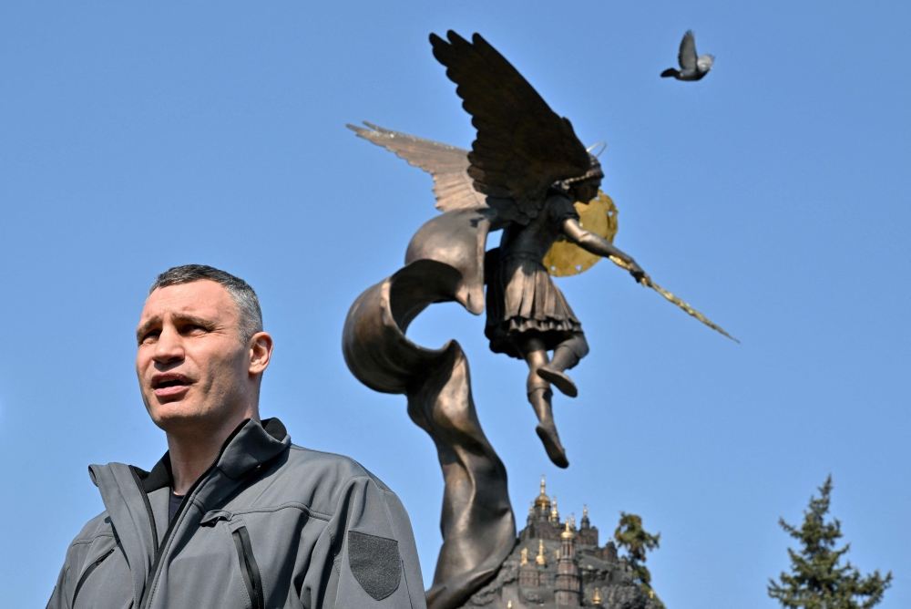 Kyiv's mayor Vitali Klitschko addresses a press conference in front of monument dedicated the the city's protector Archangel Gabriel in Kyiv. - AFP