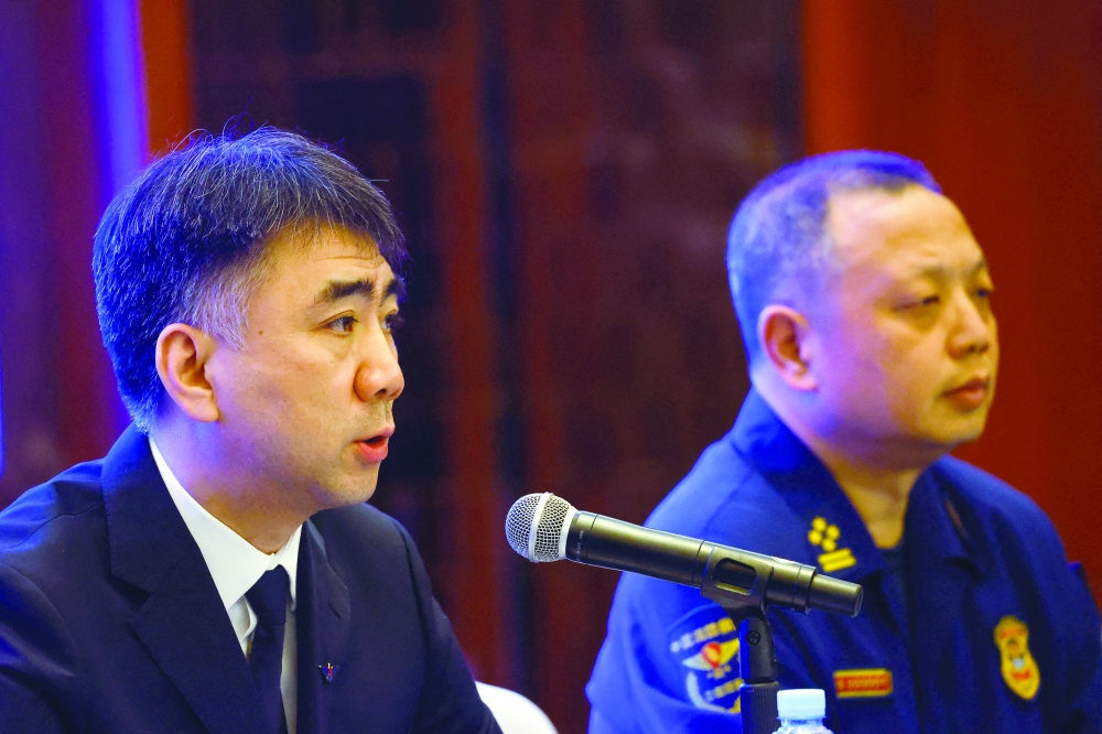 Zheng Xi, chief of Fire and Rescue Corps of Guangxi Zhuang Region and Shangguan Xuemin, official with China Eastern Airlines attend a news conference in Wuzhou. - Reuters