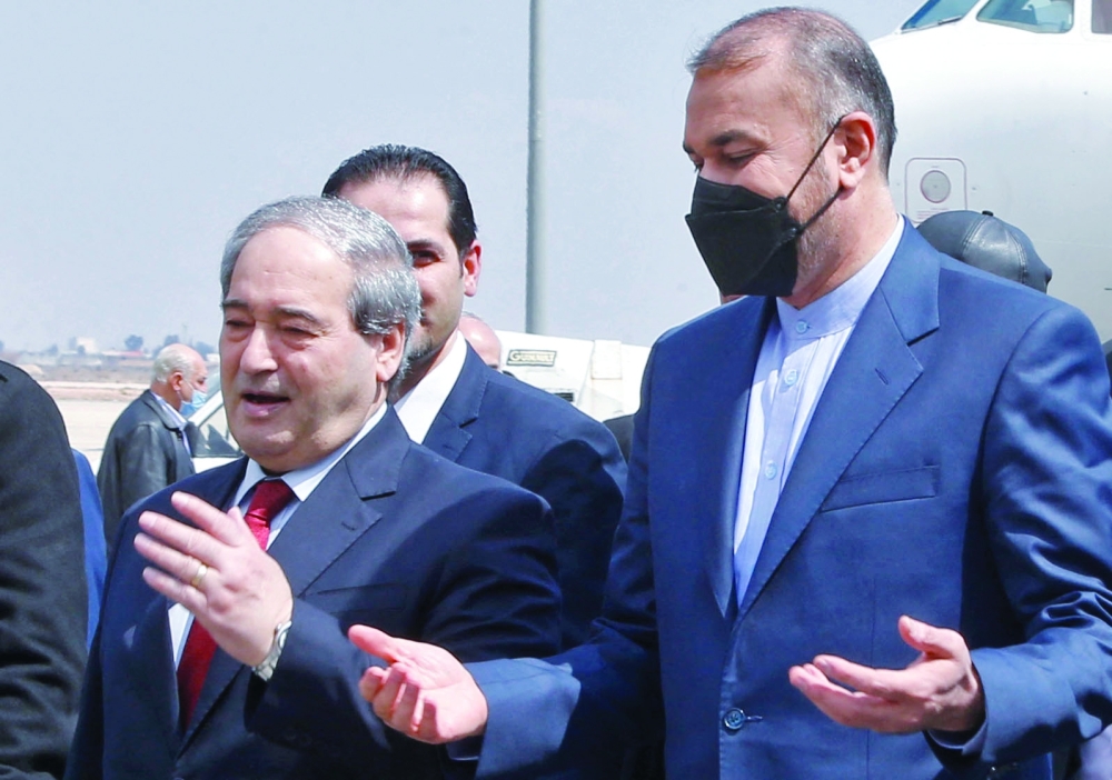 Iran's Foreign Minister Hossein Amir Abdollahian is welcomed by Syrian Foreign Minister Faisal Mekdad at the tarmac of Damascus' airport. - AFP