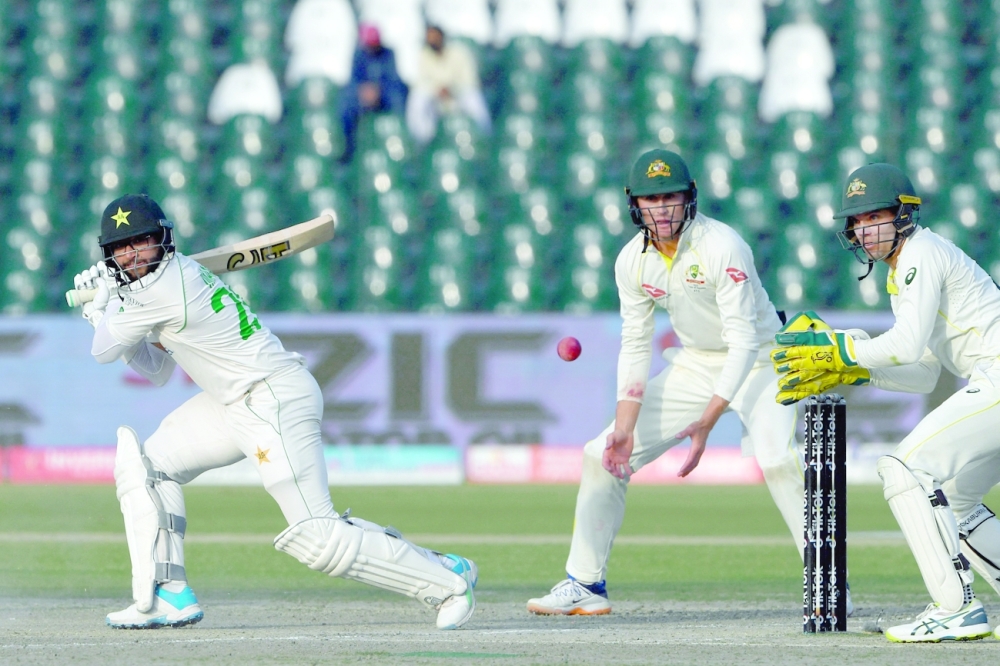 Pakistan's Imam-ul-Haq (L) watches the ball after playing a shot during the fourth day of the third and final Test. -- AFP