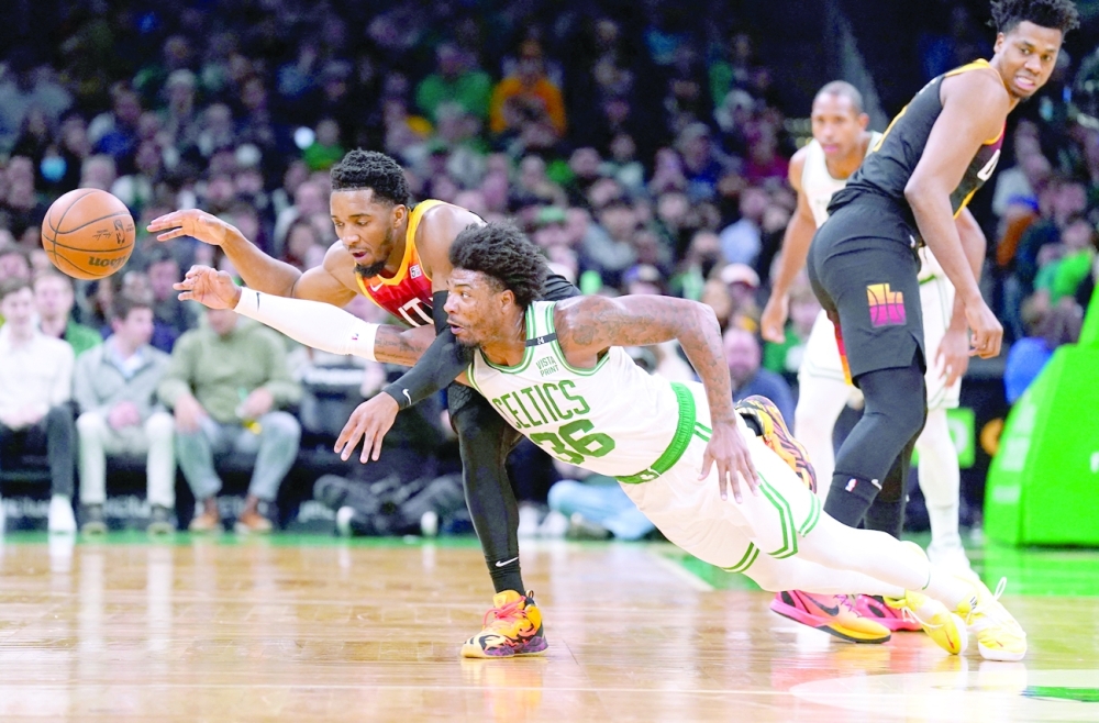 Mar 23, 2022; Boston, Massachusetts, USA; Boston Celtics guard Marcus Smart (36) and Utah Jazz guard Donovan Mitchell (45) work for the ball in the first quarter at TD Garden. Mandatory Credit: David Butler II-USA TODAY Sports