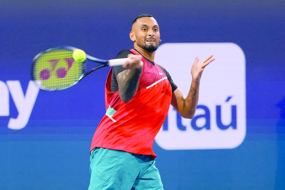 Nick Kyrgios hits a forehand against Adrian Mannarino in a first round men's singles match in the Miami Open. -- USA Today Sports
