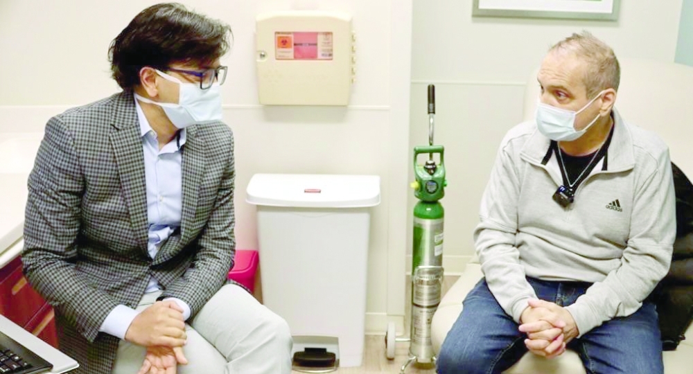 Albert Khoury (R) with surgeon Ankit Bharat in Chicago. — AFP