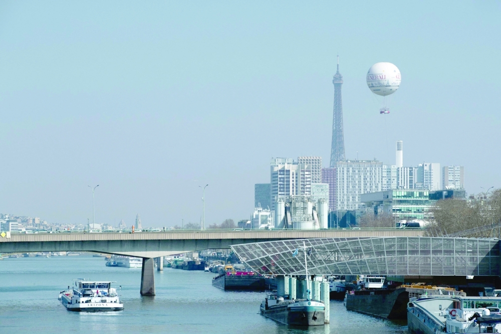 A weather balloon for monitoring the air quality in Ile-de-France region flies next to the Eiffel Tower in Paris. -- AFP