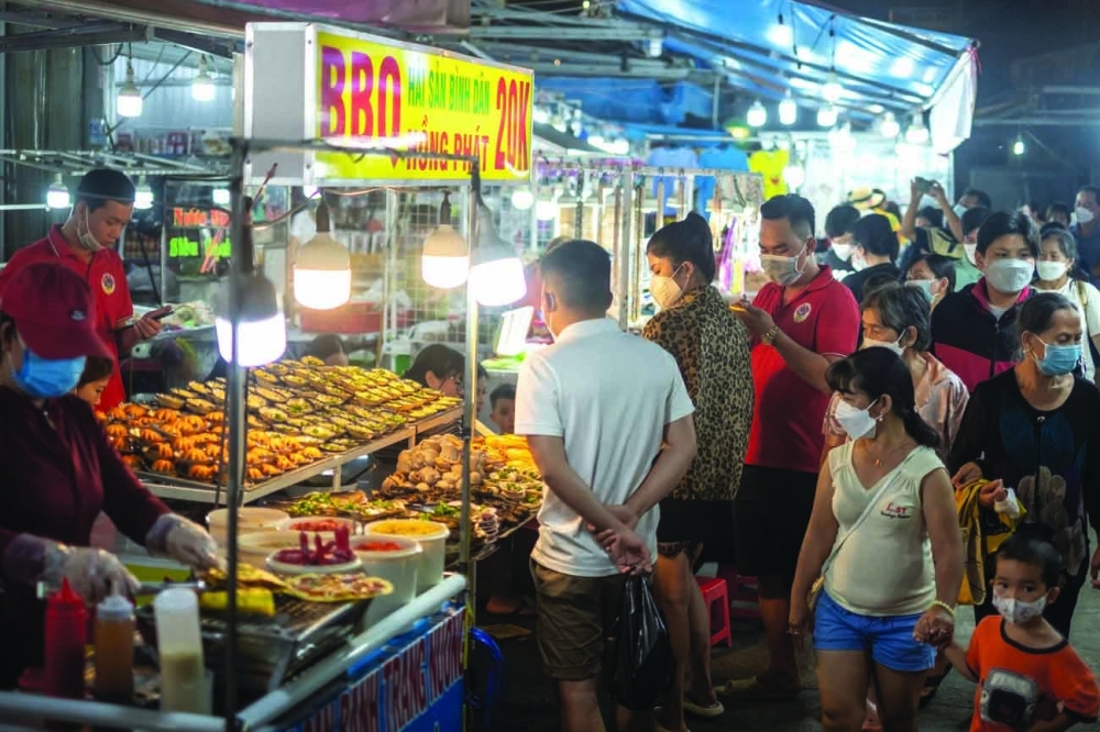 Visitors gather at a night market on Phu Quoc Island in Vietnam, Feb. 26, 2022. (Linh Pham/The New York Times)