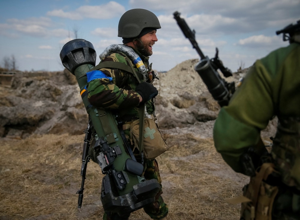 A Ukrainian service member stands at a position on the front line in the north Kyiv region