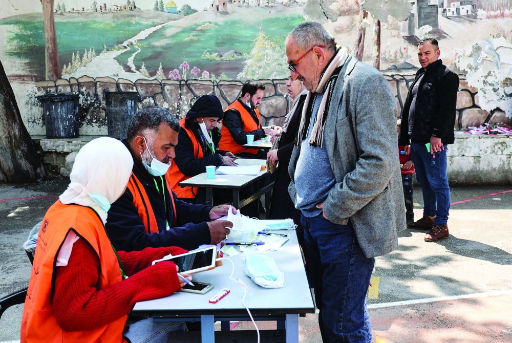 Palestinians register to vote in the local elections in Beit Furik, east of the West Bank city of Nablus. - AFP

