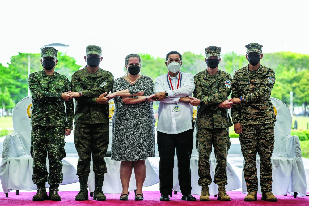 Philippine and US officials pose during the opening ceremony for a 12-day joint military drill at Camp Aguinaldo in Quezon City, east of Manila. - AFP

