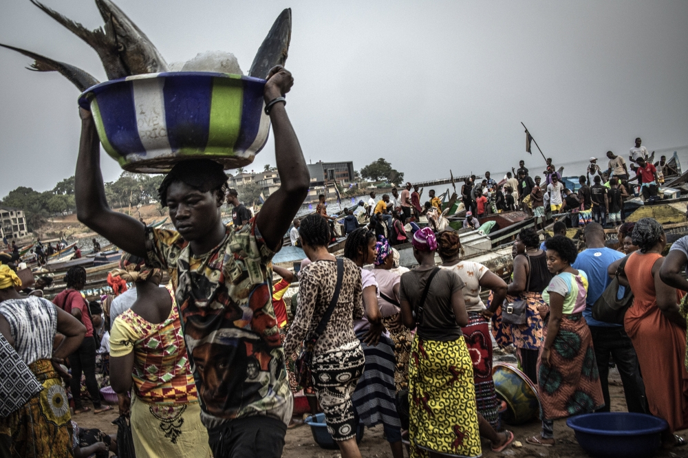 A busy morning at the fish market at Man of War Bay in Freetown, Sierra Leones capital, on Feb. 17, 2022.  (Finbarr O'Reilly/The New York Times)